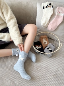 Detailed texture of thick coral fleece winter socks with cute 3D cartoon animal patterns