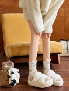 Close-up of thick coral fleece socks with 3D animal ears and cozy plush slide slippers