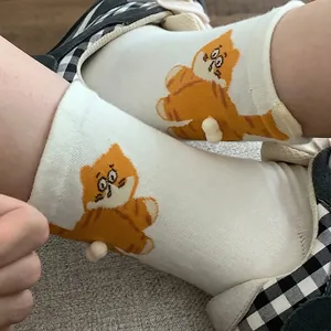 Cute mid-calf cotton socks in cream white with 3D cat tail pompom and cartoon cat design