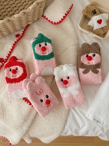 Detail of five pairs of thick pink coral fleece socks with cute 3D cartoon animal characters