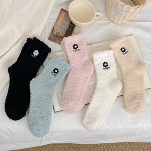 Close-up of five colorful thickened coral fleece socks with 3D pearl flower embroidery detail