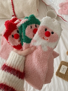 Detailed close-up of fluffy coral fleece socks featuring cute cartoon beaver designs