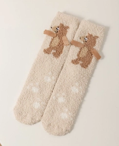 Detailed view of beige coral fleece winter socks with 3D brown teddy bear ornaments