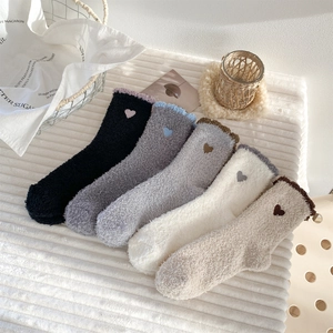 Detail of 5 pairs soft coral fleece socks with embroidered heart patterns in assorted colors