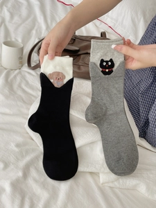 Detail of cute cat and dog embroidery on soft cotton blend turnover cuff socks