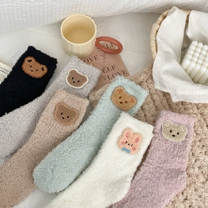 Close-up of fluffy coral fleece socks set featuring cute animal embroidery patches