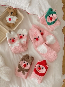 Detail of soft coral fleece socks with 3D cartoon animal designs in various pastel colors