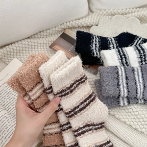 Detail of soft striped coral fleece socks in four colors for winter home warmth