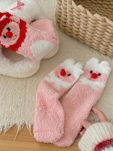 Detail of coral fleece mid-calf socks with cute cartoon embroidery and 3D plush ball