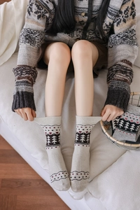 Detail of wool socks with Nordic Fair Isle knit pattern and elastic ribbed cuffs