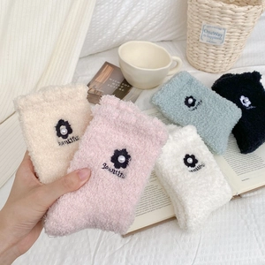 Detail showing five colors of soft coral fleece socks with 3D flower pearl embroidery