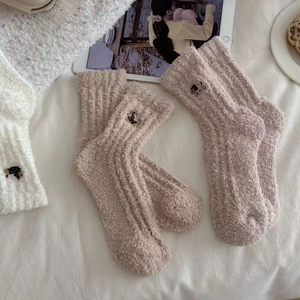 Detail of warm coral fleece mid-calf socks with cute dachshund animal embroidery