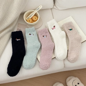 Close-up of five pairs of plush coral fleece socks with cute dachshund dog embroidery