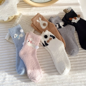 Detailed view of thick coral fleece socks with cute animal designs for winter warmth