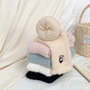 Five pairs of fluffy coral fleece socks with 3D flowers and pearls in cozy pastel tones