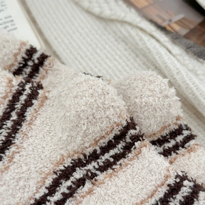 Close-up of thick coral fleece striped socks showing soft texture and cozy warmth