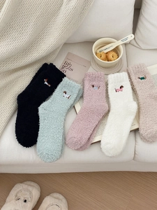 Detail of embroidered dachshund motifs on soft coral fleece socks in 5-pack assortment