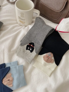 Close-up of cute cartoon cat and dog embroidery on premium cotton knitted crew socks