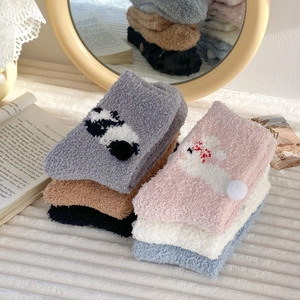 Detailed view of thick coral fleece socks in multiple colors with cute animal patterns