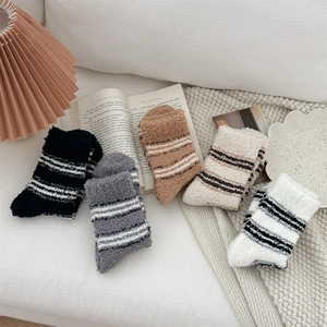Detailed view of five pairs of thick striped coral fleece socks in assorted cozy colors