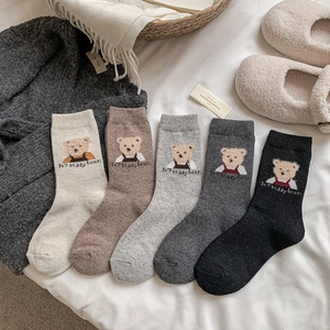 Détails de broderie d'ours sur chaussettes épaisses en laine en beige, marron et gris