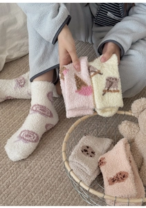 Detail of soft coral fleece socks with cute ice cream patterns for winter home warmth