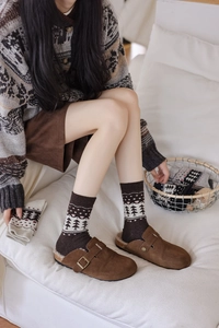 Brown suede clogs with wool lining and retro Fair Isle socks in a cozy home setting