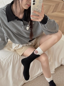 Detailed shot of cotton mid-calf socks with cute brown bear embroidery and folded cuffs