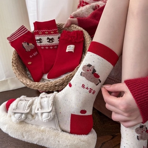 Red and cream festive cotton socks featuring horse patterns and warm winter theme