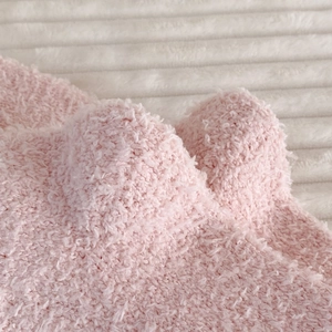 Close-up of soft pink coral fleece fabric texture for warm winter socks