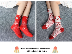 Detail of Christmas crew socks with 3D plush ears and reindeer holiday patterns