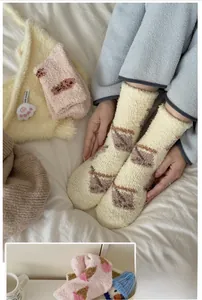 Close-up of thick coral fleece socks with geometric patterns for winter home comfort
