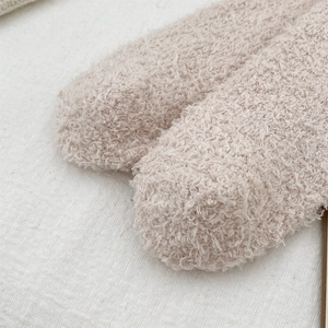 Detail of warm beige coral fleece fabric texture on thick winter indoor floor socks