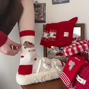 Detail of red and cream zodiac horse socks with knitting patterns and auspicious text