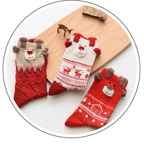 Detailed knit of festive red Christmas crew socks featuring 3D elk ears and Nordic patterns
