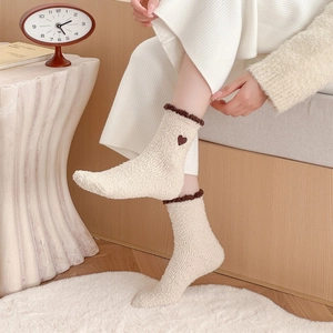 Cozy cream coral fleece socks with brown embroidered heart and ruffle trim for winter