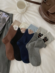 Detailed view of cotton socks with cute animal embroidery and folded ribbed cuffs