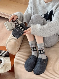 Detail of Nordic wool socks with tree pattern and ribbed cuffs for winter warmth