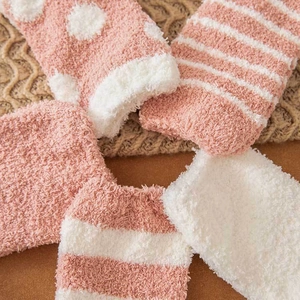 Thick coral fleece socks for women in soft pink and white with warm plush texture