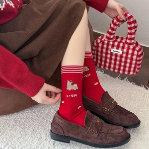 Detail of red festive cotton socks with horse embroidery and Chinese luck symbols