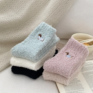 Detail of dachshund embroidery on colorful thick coral fleece thermal socks set