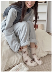 Thick fleece socks with brown bear pattern and matching plush storage bag