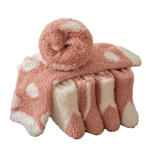 Thick coral fleece socks for women in pink and white polka dot design for winter warmth