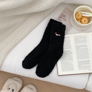 Close-up of black coral fleece winter socks featuring dachshund puppy embroidery decor