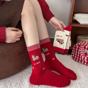 Detail view of red cotton crew socks featuring a cartoon horse and striped ribbed cuffs