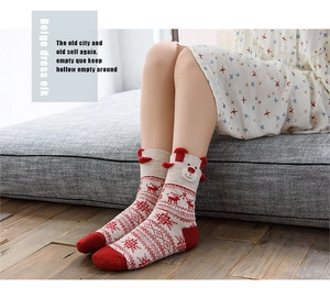 Detail of beige knit Christmas sock with red elk jacquard and 3D plush ears decor
