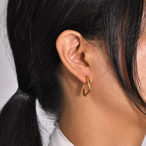 Elegant gold twisted hoop earrings for women featuring a minimalist polished metal texture