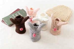 Detailed view of assorted fluffy coral fleece bunny socks with 3D ears and soft textures