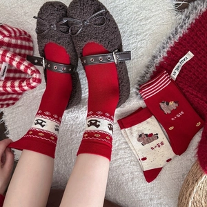 Detail of red festive crew socks with horse pattern paired with brown Mary Jane shoes