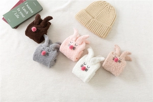 Close-up of fluffy coral fleece bunny socks in five colors with cute 3D ears and pom-poms